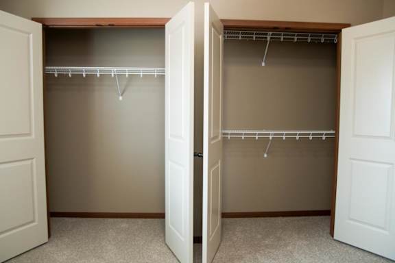 A room with two open closets.