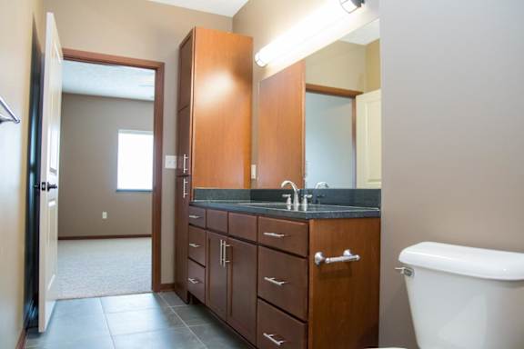Bathroom with large vanity with linen storage connected to vanity