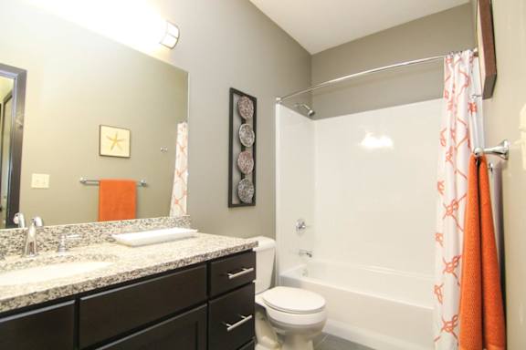 A bathroom with a toilet, sink, and shower.