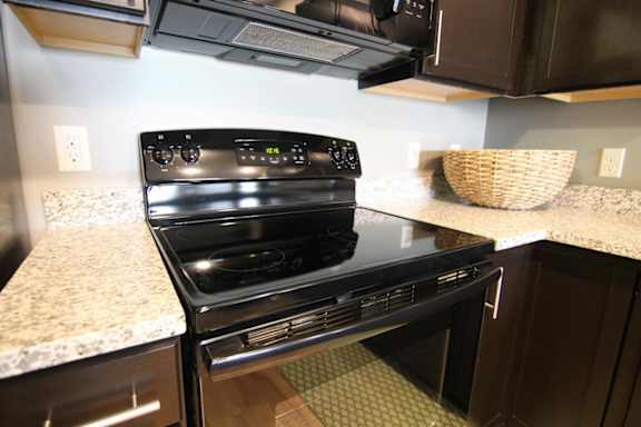 A black stove top oven with a digital display in the middle.
