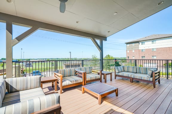 a spacious deck with couches and a coffee table