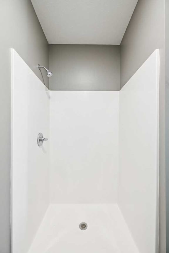 A white walk in shower insert.