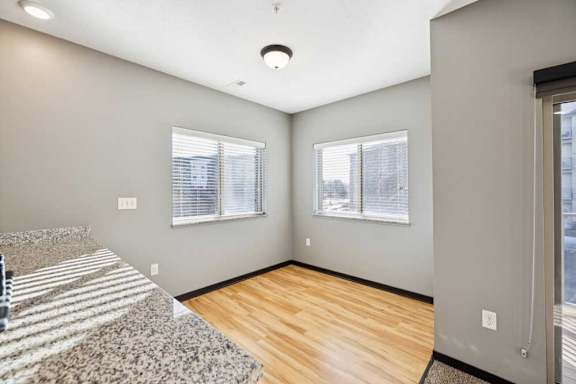 A dining room with wooden flooring.