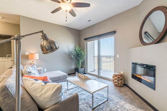 Open layout living room with fireplace at The Flats at 84 in southeast Lincoln NE 68516