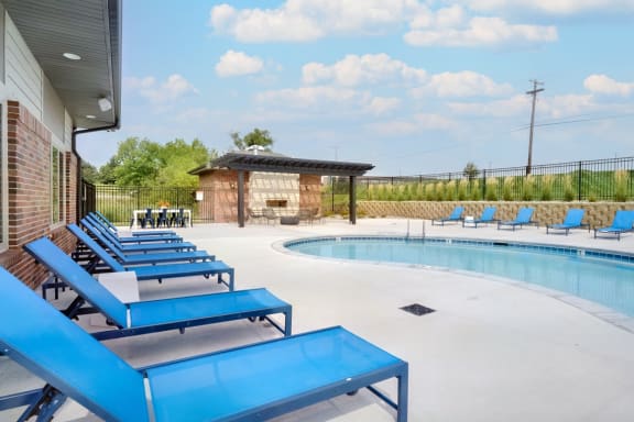 Resort style pool with lounge chairs outside the clubhouse at The Flats at Shadow Creek