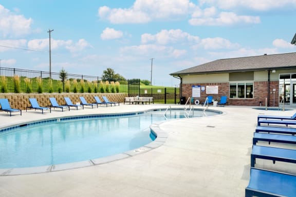 Resort style pool with lounge chairs outside the clubhouse at The Flats at Shadow Creek