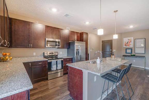 a kitchen with granite counter tops and stainless steel appliances