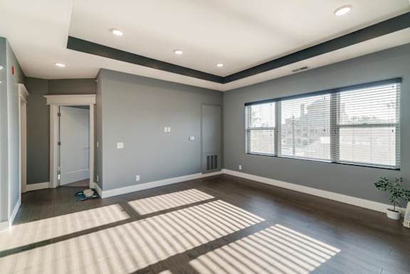 Living room with wide window and dark brown wood floors