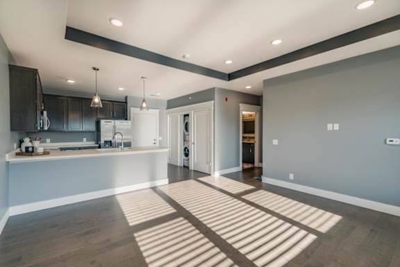 A modern kitchen with a large peninsula and open living area