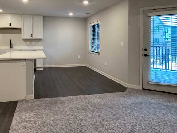 dining area with wood-look flooring and a window