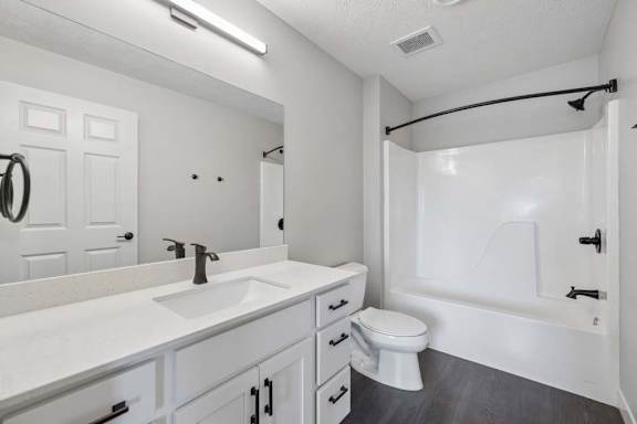 Apartment bathroom with white vanity, black fixtures, and tub-shower combination.