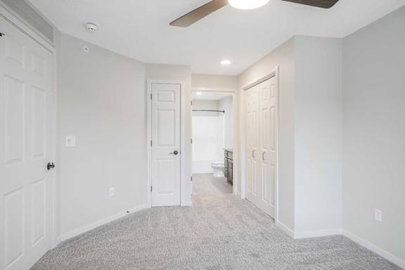 The primary bedroom in the Dove featuring dual closets and an attached bathroom