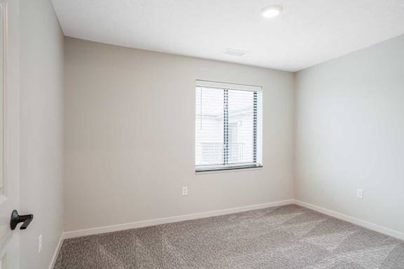 The second bedroom in the Dove floorplan featuring a window