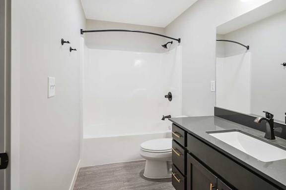 The hallway bathroom featuring a tub shower with modern dark finishes