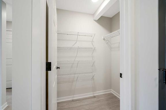 A walk-in kitchen pantry featuring built-in shelving