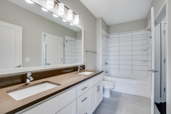 You'll love the bathroom with dual vanities and custom-tiled tub and shower