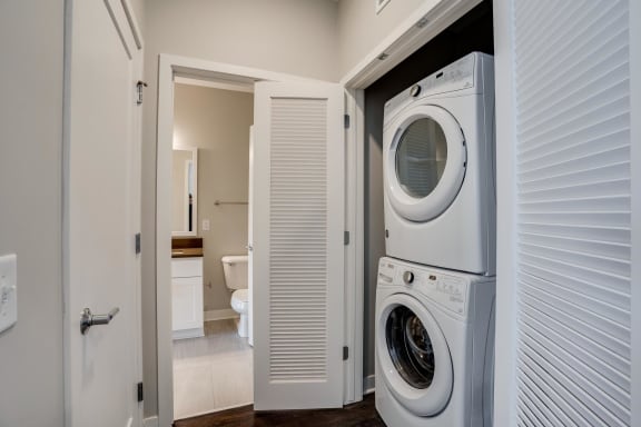 A stacked full size washer and dryer is included in the 2 bedroom Harriet floor plan