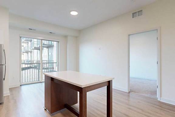 Kitchen and dining area with patio door and moveable island