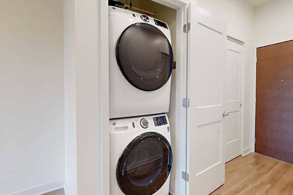 Stacked front loading washer and dryer in a closet