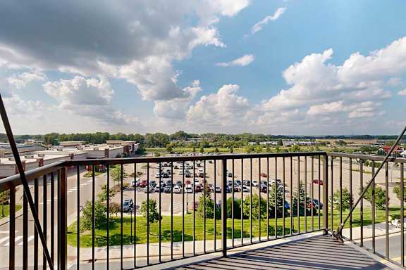 Apartment balcony overlooks a parking lot