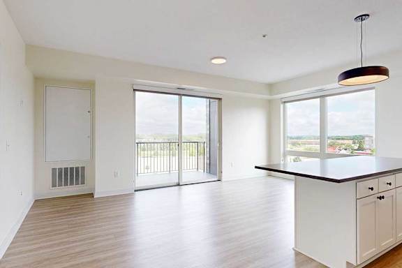 A spacious kitchen with white cabinets and a large island.
