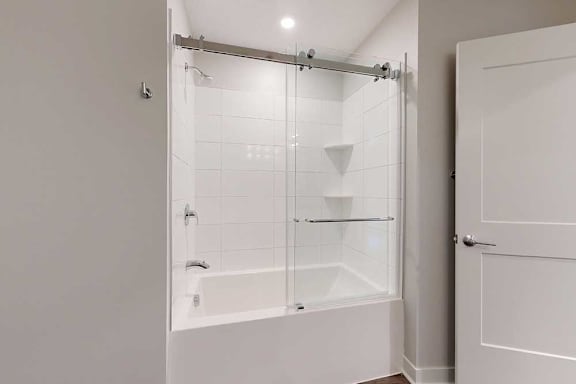 A white bathroom with a walk-in shower.