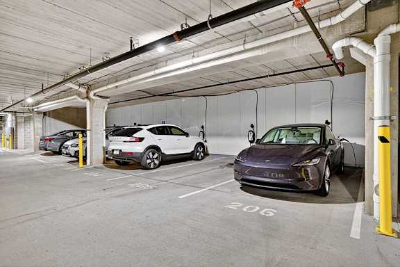 Two cars are parked in a parking garage.