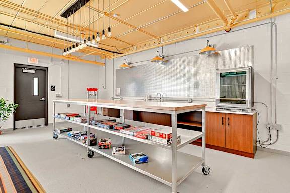 A room with a metal cart and a cabinet.