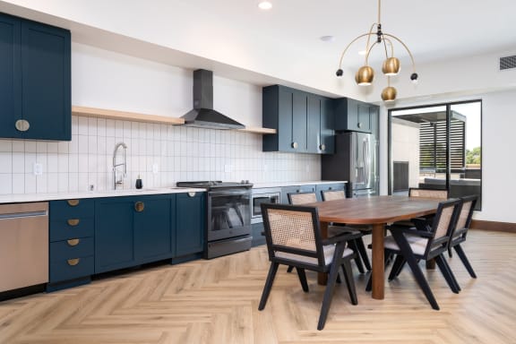 Community space with kitchen and table with seating at The Rowan