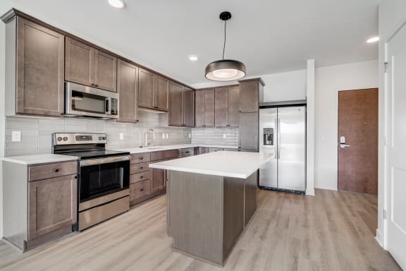 Spacious open kitchen with matching steel appliances and plenty of cabinet storage space at The Rowan in Eagan Minnesota