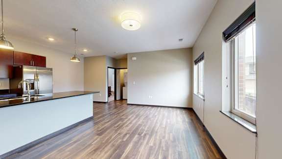 Open living room and kitchen with large windows