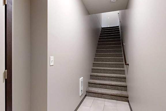 An entryway with a stairway leading up to the living area.