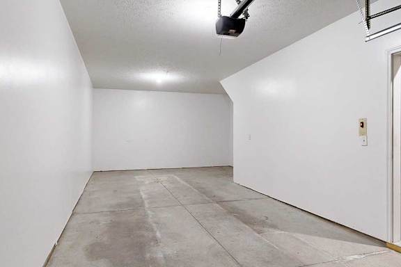 A two-car tandem garage with an extra built-in storage space under the stairs.