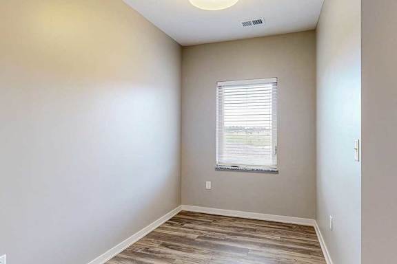 A nook area with hardwood-style flooring and a large window.