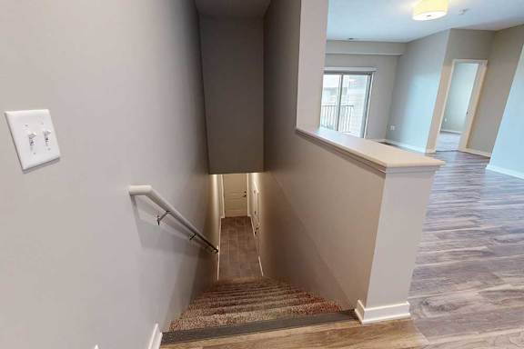 A staircase the connects the living area down to the front entry.