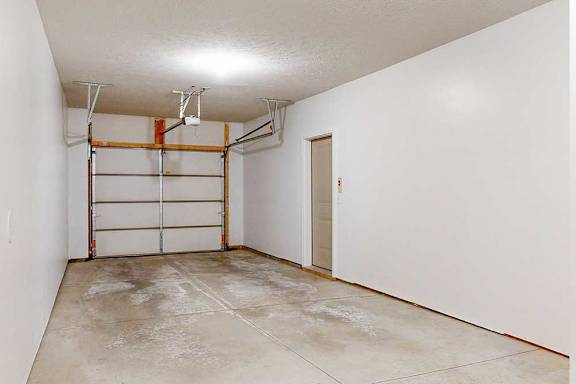 A two-car tandem garage directly attached to an apartment.