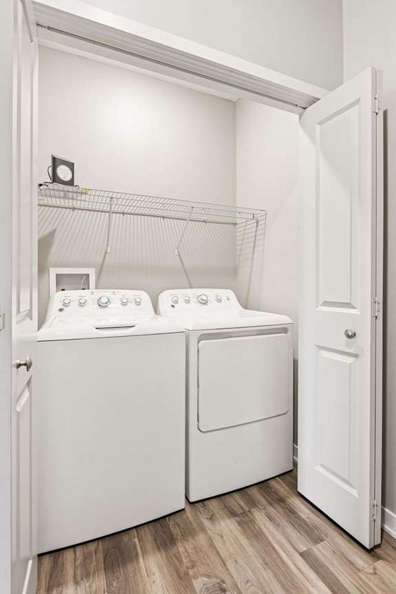 A white laundry room with a washer and dryer.