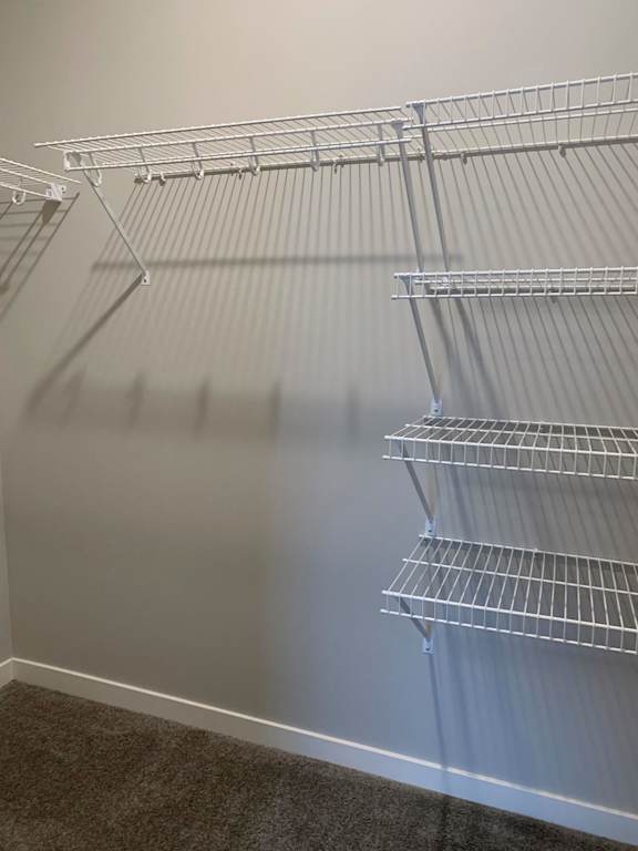 Empty wire shelving in a room.