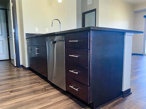 A kitchen island with a dishwasher underneath it.