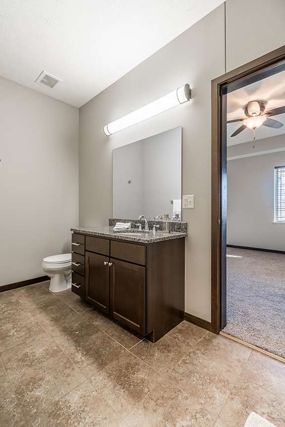 Upscale bathroom with granite countertops and attached walk in closet at the Villas at Wilderness Ridge in Lincoln Nebraska