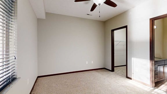 a bedroom with an attached walk-in closet and an attached bathroom