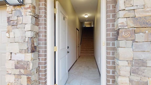 a private front entryway that leads to an attached garage and staircase