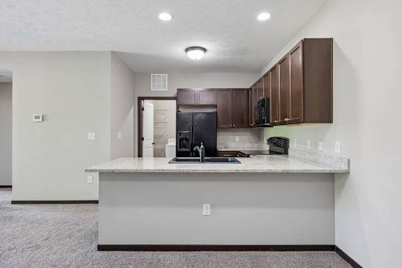 A kitchen with a white countertop and brown cabinets.