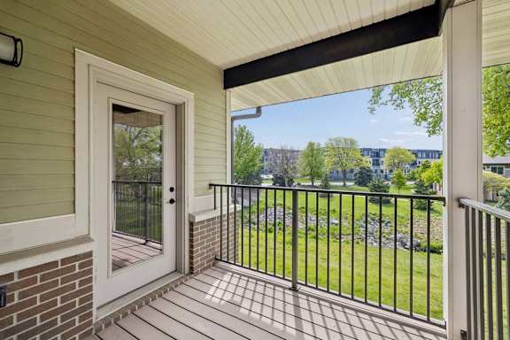 A view from a doorway looking out to a green lawn.