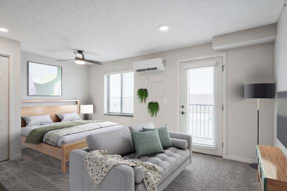 A bedroom with a bed, a couch, and a ceiling fan.
