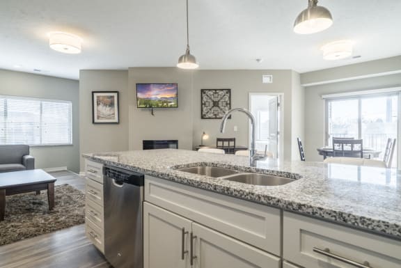 Kitchen with granite counter tops and white cabinets at The Villas at Mahoney Park