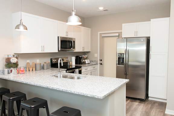 white cabinet kitchen with bar stool seating