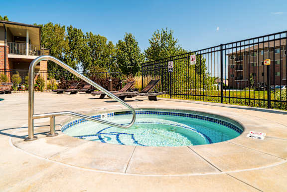 round hot tub on the pool deck at Villas of Omaha at Butler Ridge apartments