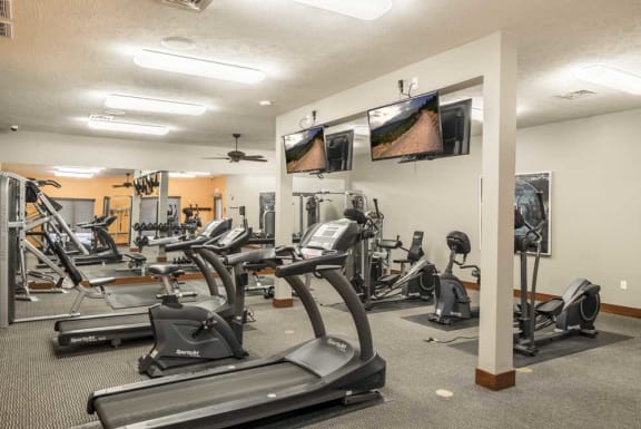 Expansive 24-hour fitness center with cardio equipment, TVs and more at Villas of Omaha townhome apartments in northwest Omaha NE 68116