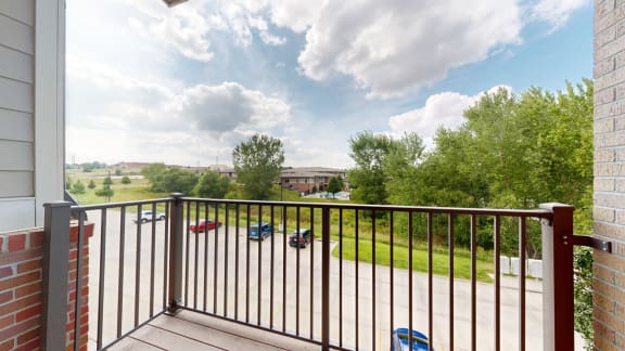 a balcony with a view of the community and clubhouse